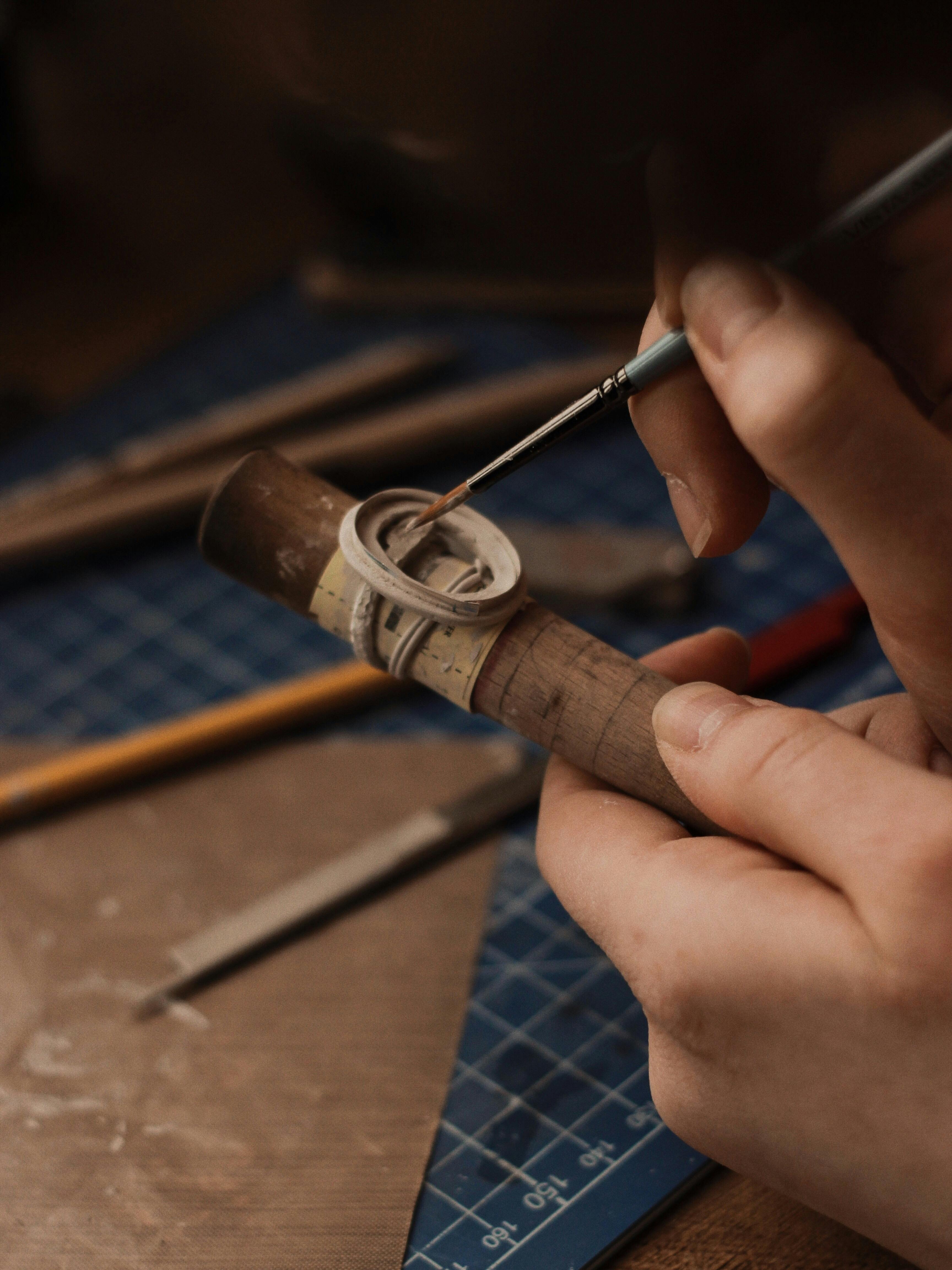 Hands crafting jewelry with tools