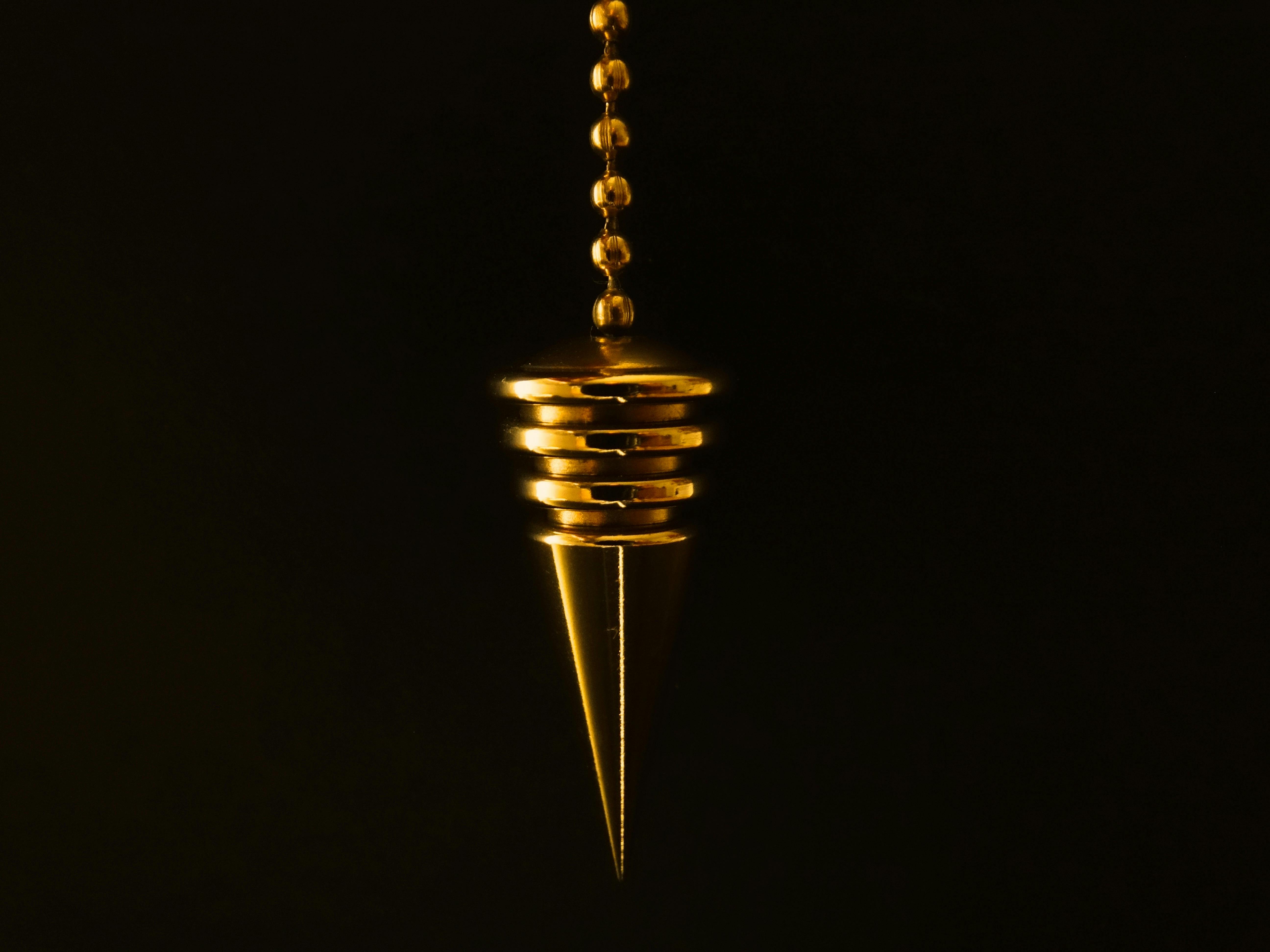 Gold pendant on black background