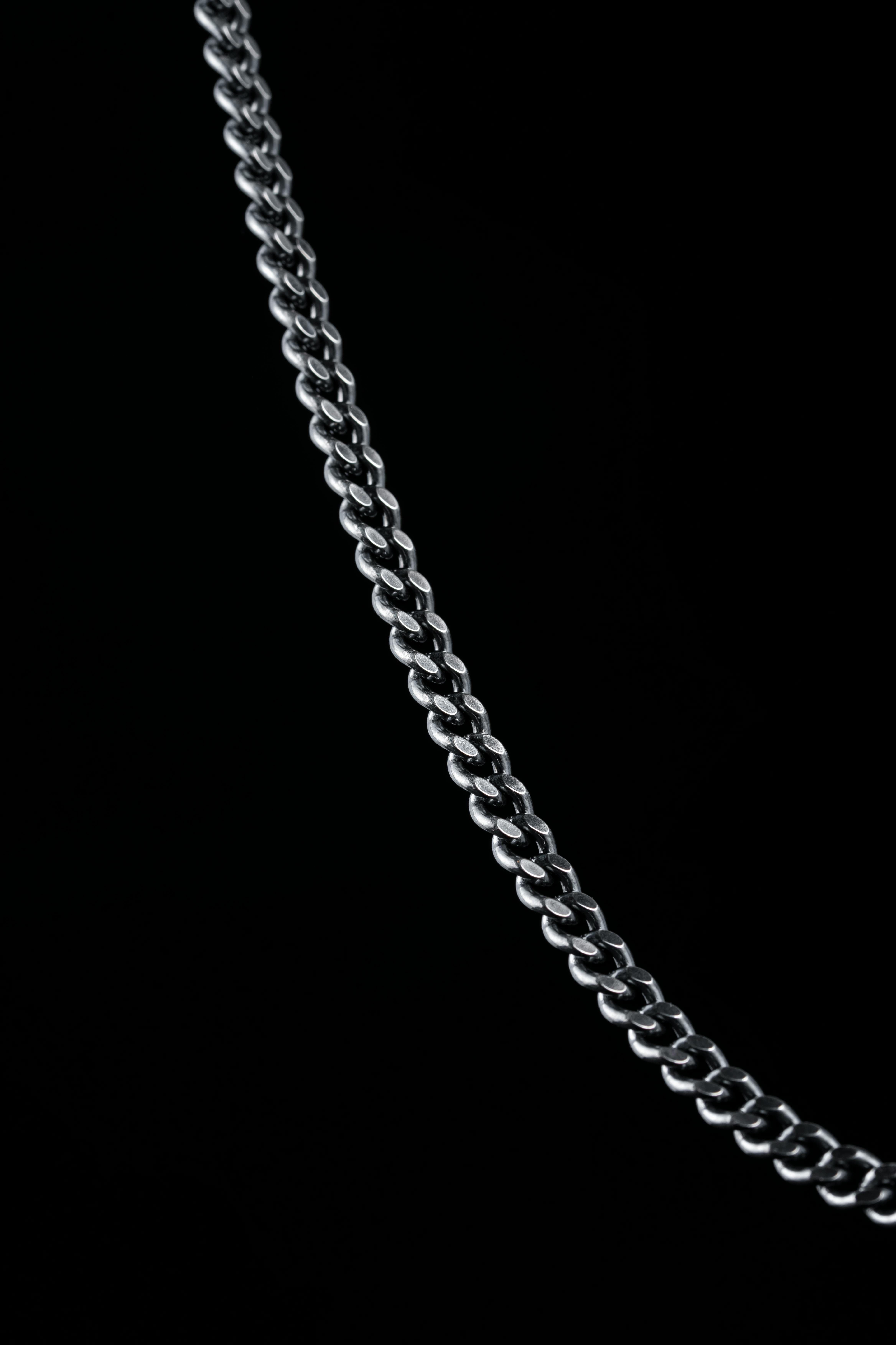 Silver chain on a dark background